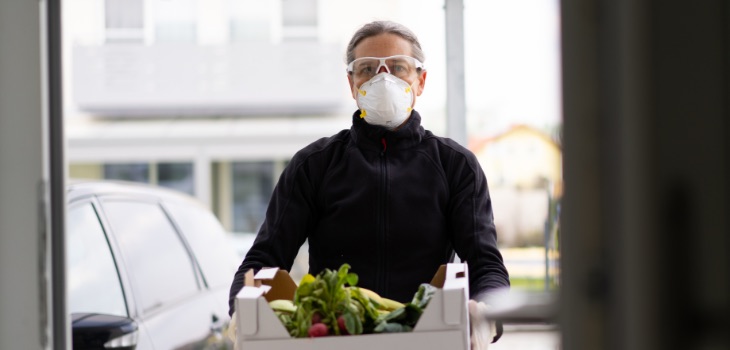 Man Delivering veggies with mask on
